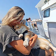 Vlady participe au concours pour gagner de l'argent avec cette photo : woman, dog, hugging, boat, outdoor, sunny, sea, blue_sky, glasses, shorts, chair, relaxing, pet, happy, leash, casual_clothing, daytime, people, vacation, nature