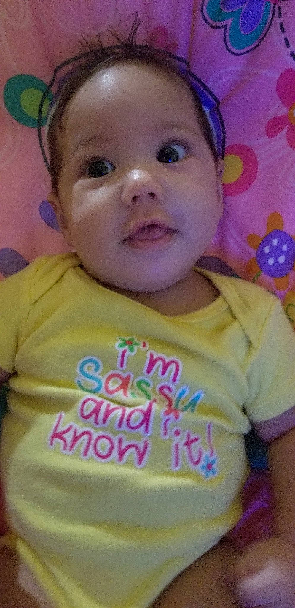 Raven is registered to the contest to win money with this photo: baby, cheek, child, chin, face, facial_expression, forehead, fun, happy, head, lip, mouth, nose, person, pink, play, skin, smile, toddler, yellow