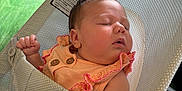 Zahra is registered to the contest to win money with this photo: baby, baby_clothes, bouncer, child, closeup, comfort, cute, face, green_carpet, head, indoor, infant, peaceful, peach_outfit, person, pink_trim, relaxation, rest, sleeping, toy