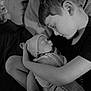 child, newborn, baby, swaddle, blanket, sleeping, cradle, love, family, monochrome, black_and_white, portrait, indoor, cozy, peaceful, infant, toddler, sibling, face, head