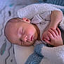 baby, sleeping, blanket, infant, hands, cozy, nursery, soft_focus, peaceful, face, skin, newborn, child, resting, cute, clothing, bed, portrait, indoors, toddler
