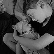 Aidan is registered to the contest to win money with this photo: child, newborn, baby, holding, swaddled, blanket, sleeping, tender, black_and_white, portrait, family, love, indoor, cozy, sibling, gentle, closeup, peaceful, person, headwear