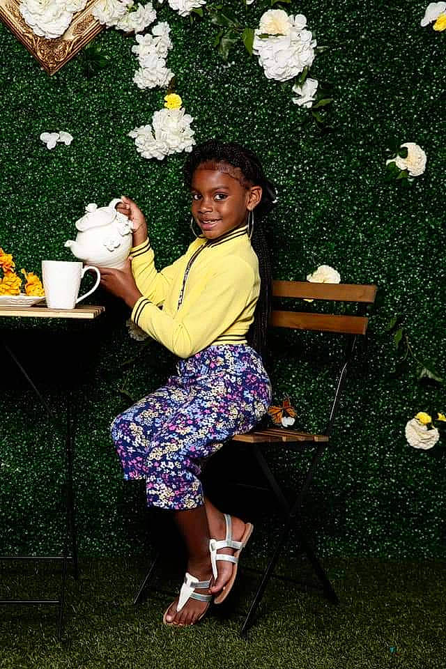 Kassandra is registered to the contest to win money with this photo: child, flower, fun, grass, joy, person, photography, plant, shoe, sitting, toddler, yellow