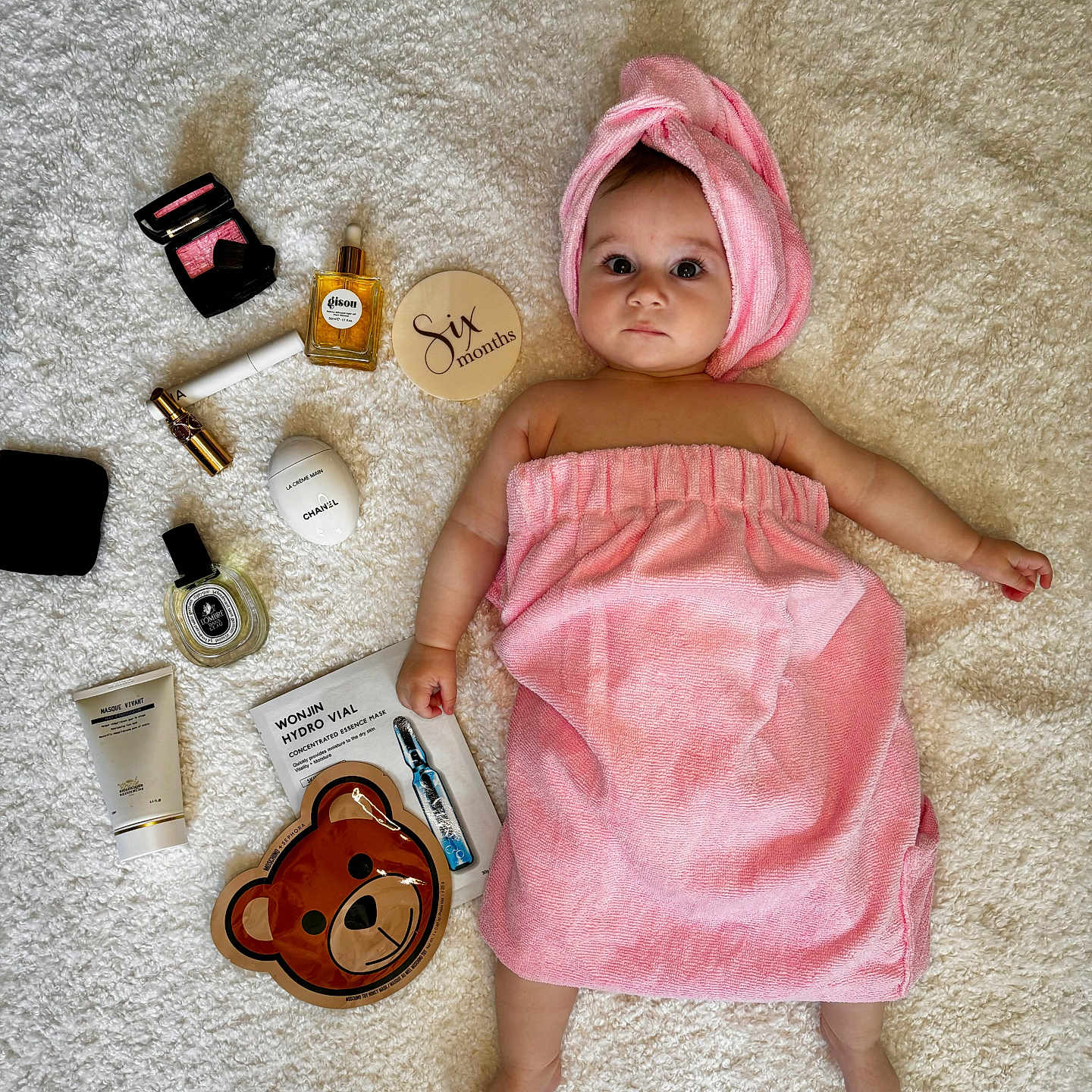 Aelita Misha joined the competition — help win amazing prizes! adorable, baby, baby_skin, bear_face_mask, beauty_products, child, cosmetics, curious, cute, face_mask, infant, laying_down, milestone, pink_towel, portrait, six_months, skincare_products, soft_texture, towel_turban, white_blanket