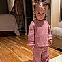 Aelita Misha joined the competition — help win amazing prizes! child, pajamas, indoor, wooden_floor, pigtails, rug, pink_clothing, person, home, curious, floor, furniture, bedroom, door, carpet, standing, toddler, light, warm_lighting, expression