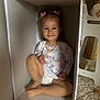 Aelita Misha joined the competition — help win amazing prizes! toddler, child, smile, face, hair_bows, storage_box, diaper, long_sleeve_shirt, carpet, doll, chair, indoor, cute, happy, sitting, toy, person, playful, home, cozy