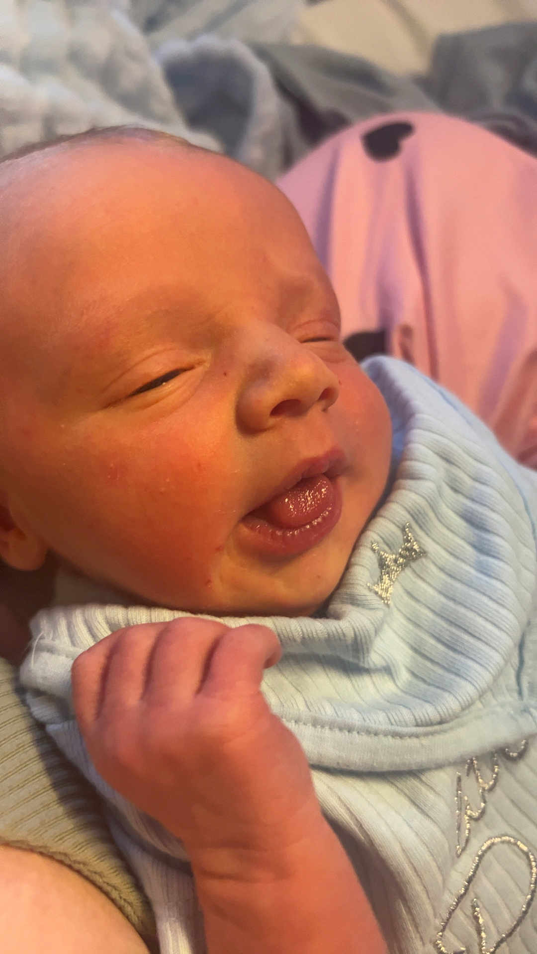 Mason joined the competition — help win amazing prizes! newborn, baby, infant, face, hand, tongue, skin, clothing, blue, closeup, expression, sleepy, cute, soft, resting, human, child, portrait, indoors, comfort