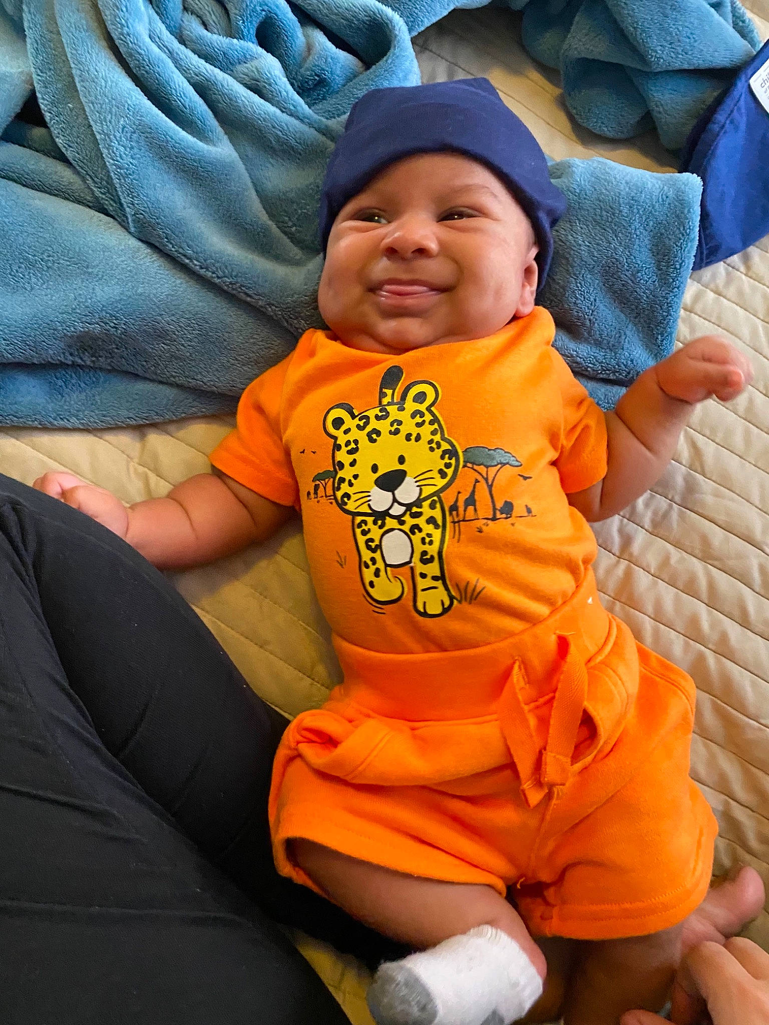 Kenzo is registered to the contest to win money with this photo: baby, baby_toddler_clothing, cheek, child, comfort, cool, fun, grass, happy, hat, headwear, leisure, linens, orange, person, sitting, sleeve, smile, t_shirt, thigh