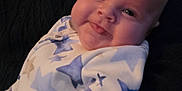 Jasper is registered to the contest to win money with this photo: baby, cheeks, child, clothing, cuddly, cute, expression, eyes, face, hand, head, infant, person, portrait, skin, sleeve, star_pattern, texture, tongue, warm
