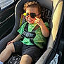 Jeremiyahh is registered to the contest to win money with this photo: toddler, child, car_seat, sunglasses, green_shirt, black_shorts, car_interior, seatbelt, smiling, sunlight, window, safety, cute, happy, young_child, portrait, casual_clothing, seat, travel, daylight