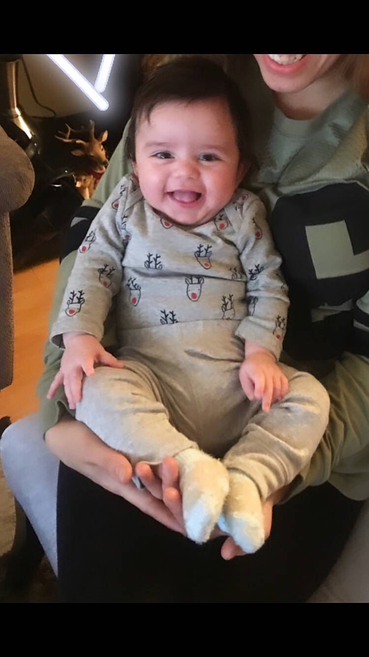 Cesar is registered to the contest to win money with this photo: arm, baby, baby_in_car_seat, car_seat, cheek, child, joy, person, play, sitting, skin, sleeve, smile, toddler