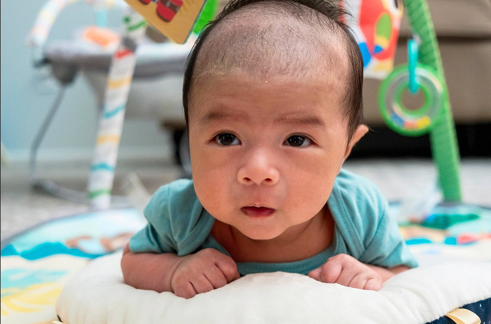 Leon is registered to the contest to win money with this photo: baby, baby_toddler_clothing, cheek, child, chin, eye, finger, fun, green, hairstyle, happy, iris, leisure, nose, person, skin, smile, summer, toddler, tummy_time