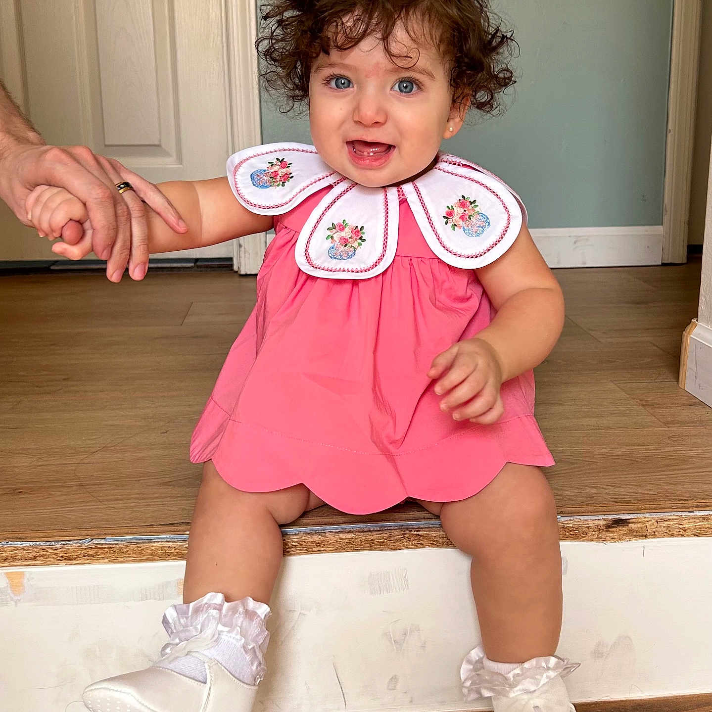 Azriella is registered to the contest to win money with this photo: baby, bodypart, brownhair, clothing, dress, face, finger, footwear, hair, hand, hardwood, head, person, photography, portrait, shoe, sitting, sleeve, stainedwood, wood