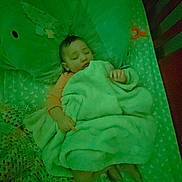 Jazmine is registered to the contest to win money with this photo: baby, sleeping, blanket, crib, pillow, infant, child, bed, sleep, soft, knitted_blanket, cozy, indoors, rest, peaceful, cute, toddler, covering, nursery, calm