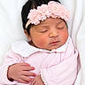 newborn, baby, sleeping, portrait, flower_headband, pink_clothing, blanket, swaddled, peaceful, face, closed_eyes, indoors, soft_lighting, infant, hands, lace, floral, cute, cozy, photography