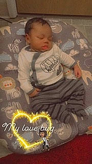 Javion is registered to the contest to win money with this photo: baby, baby_toddler_clothing, cheek, child, comfort, cool, event, fictional_character, flooring, fun, fur, happy, pattern, person, photo_caption, play, room, sitting, sleeve, toddler