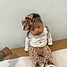Ameri joined the competition — help win amazing prizes! baby, infant, child, portrait, sitting, smiling, bow, headband, leopard_print, outfit, shoes, fashion, brown, white, indoor, changing_table, wall, hand, adorable, photography