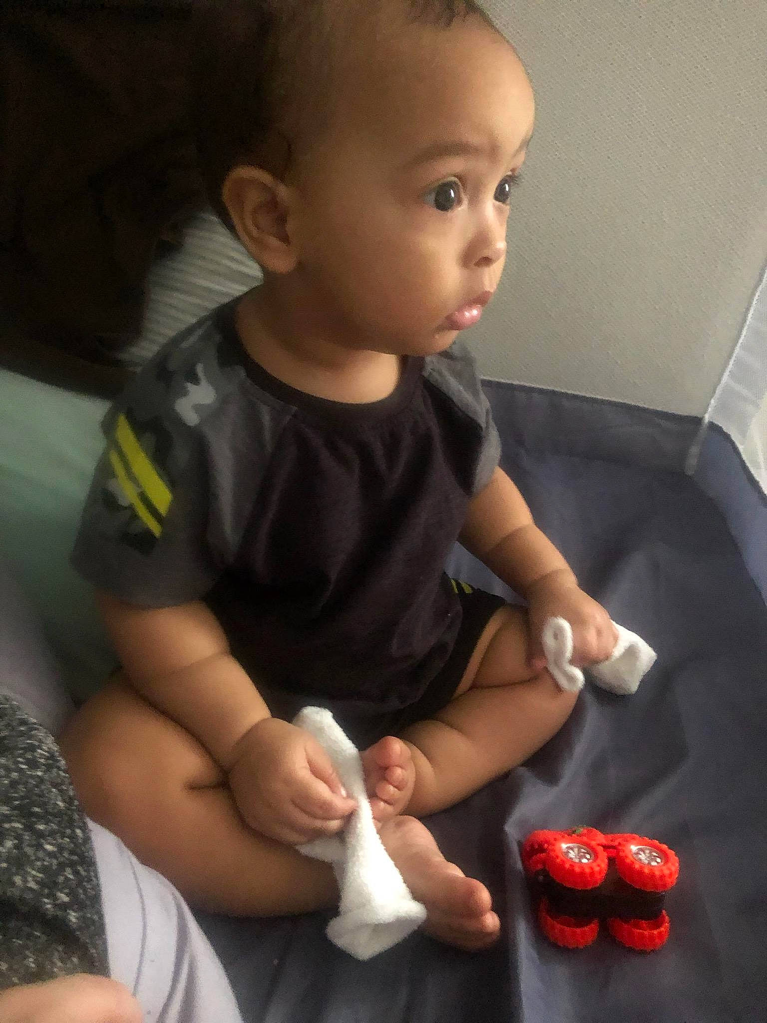 Dominique is registered to the contest to win money with this photo: baby, baby_toddler_clothing, comfort, elbow, finger, flooring, fun, hand, happy, head, joint, knee, mouth, nail, nose, person, skin, sleeve, surprise, thigh