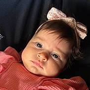 Serena joined the competition — help win amazing prizes! baby, infant, face, headband, pink_clothing, portrait, closeup, child, cute, skin, hair, expression, eyes, young, person, fashion, texture, soft_lighting, indoors, serious