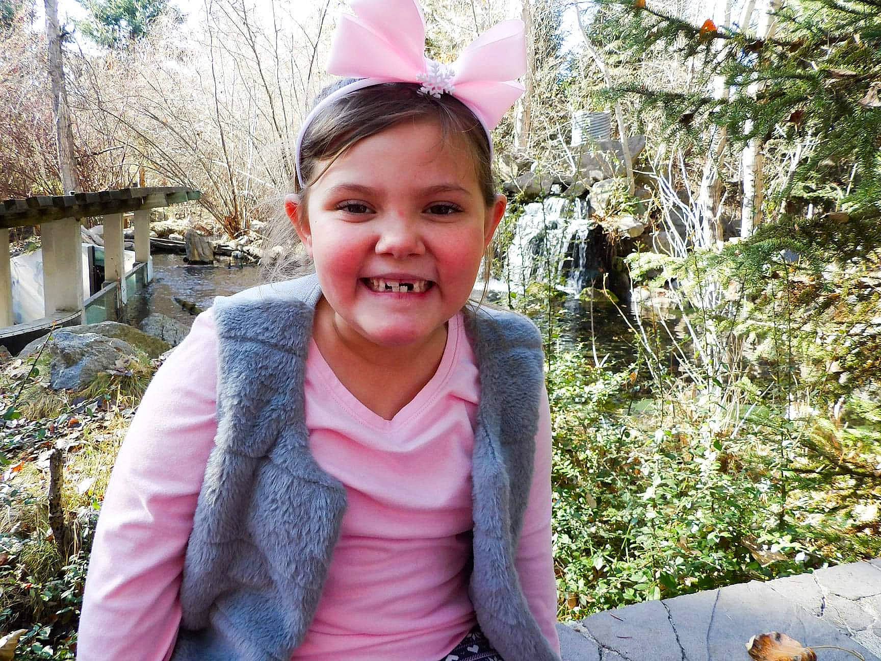 Abi joined the competition — help win amazing prizes! botany, cap, child, fashion_accessory, fun, grass, happy, headpiece, jewellery, joy, leisure, magenta, outerwear, person, pink, plant, recreation, sitting, smile, toddler