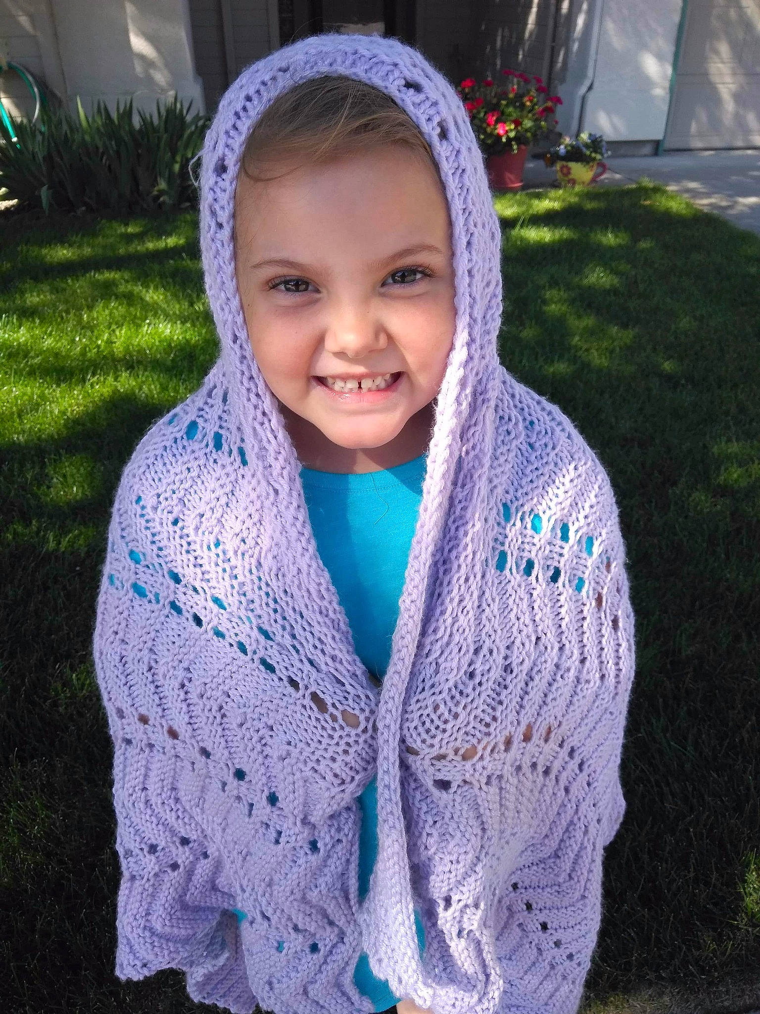 Abi is registered to the contest to win money with this photo: art, blue, child, clothing, craft, crochet, fashion_accessory, joy, knitting, lace, outerwear, person, plant, scarf, shawl, smile, sweater, textile, thread, turquoise