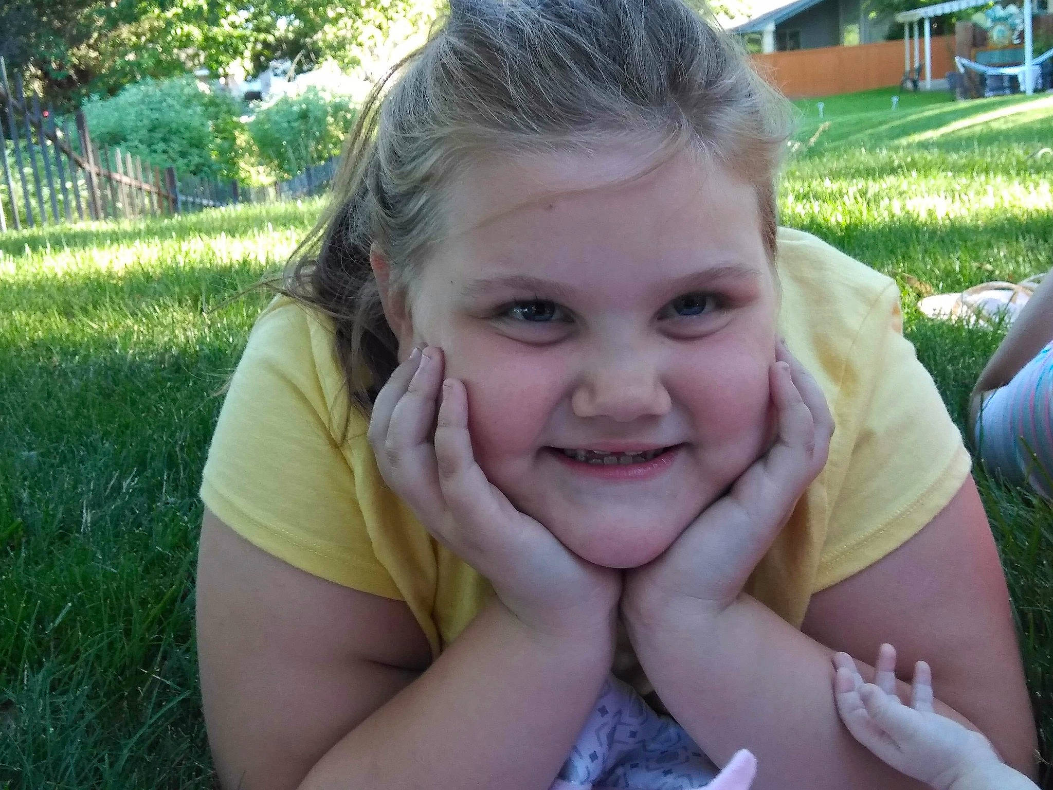 Justice is registered to the contest to win money with this photo: blond, child, face, facial_expression, fun, grass, happy, head, joy, laugh, lawn, lip, mouth, nose, person, skin, smile, summer, tooth