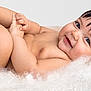 baby, infant, smile, happy, skin, hair, blanket, soft, cute, playful, child, lying_down, touching_toes, naked, portrait, indoors, closeup, flesh, young, cozy
