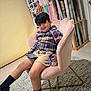 Andrew Matteo Romero is registered to the contest to win money with this photo: child, boy, chair, tablet, water_bottle, plush_furniture, fabric_rolls, flowers, indoor, casual_clothing, plaid_shirt, shorts, socks, shoes, carpet, wooden_floor, relaxed, smiling, modern_decor, home