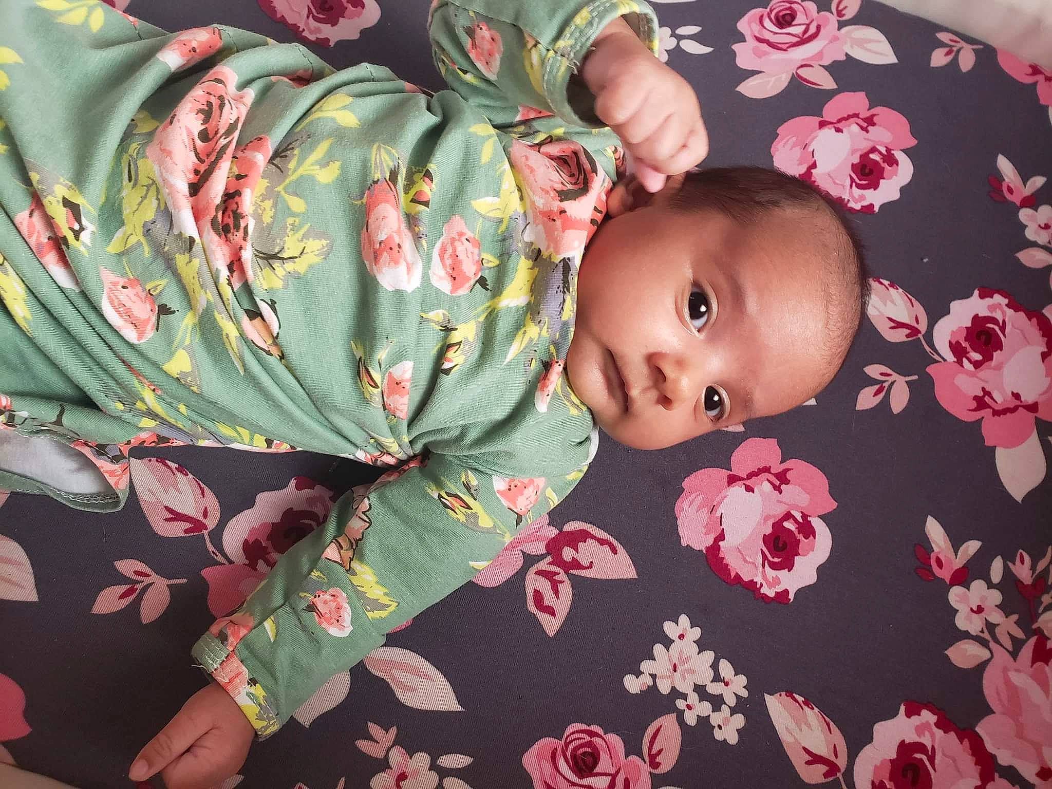 Stormi joined the competition — help win amazing prizes! baby, baby_toddler_clothing, cheek, child, comfort, facial_expression, flooring, hairstyle, leaf, linens, mammal, military_camouflage, pattern, person, pink, room, skin, sleeve, textile, toddler