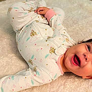 Lyla joined the competition — help win amazing prizes! baby, blanket, child, clothing, cozy, dark_hair, eyes, face, fluffy_blanket, happy, indoor, infant, laughing, lying_down, mouth, pajamas, photography, portrait, smiling, 床