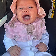 Callie joined the competition — help win amazing prizes! baby, infant, smiling, pink_hat, pink_bib, white_clothing, car_seat, happy, child, portrait, cute, small_hands, face, comfort, seatbelt_warning, indoors, closeup, headwear, baby_clothes, human