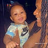 baby, child, adult, smiling, nike, shirt, braids, holding, love, night, portrait, person, affection, happy, outdoor, dark_background, skin, face, hand, clothing