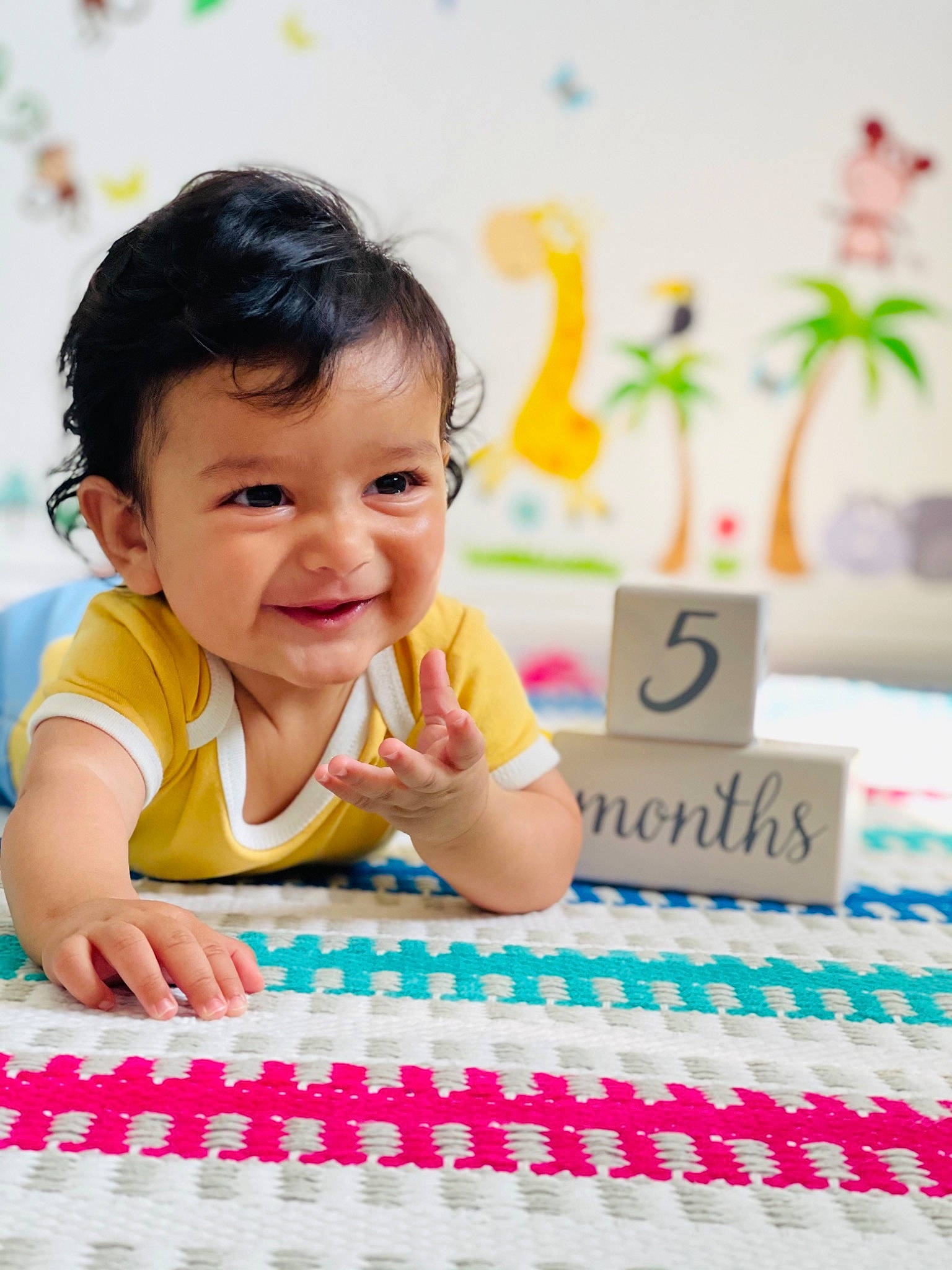 Yug is registered to the contest to win money with this photo: baby, baby_playing_with_toys, baby_toddler_clothing, beauty, child, flooring, fun, happy, joy, leisure, pattern, person, pink, play, recreation, sitting, skin, smile, sweetness, t_shirt