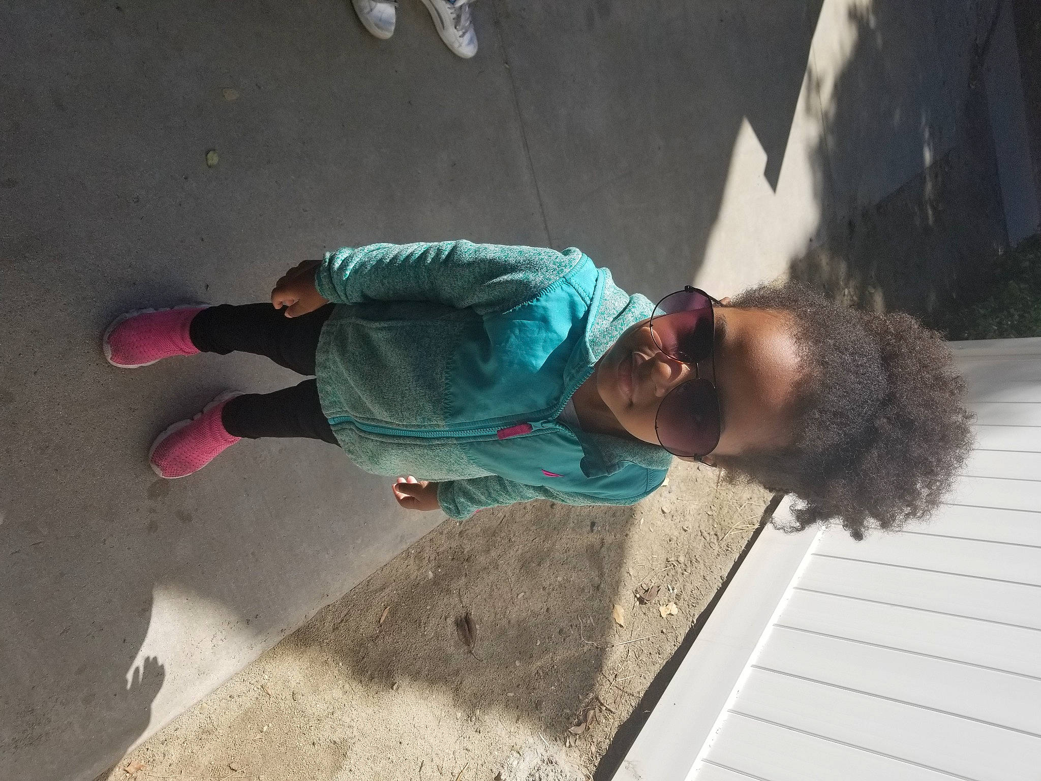 Ahparyam is registered to the contest to win money with this photo: asphalt, child, concrete, cool, denim, eyewear, flooring, fun, leisure, pedestrian, person, recreation, road, road_surface, shadow, sidewalk, sitting, soil, street, street_fashion