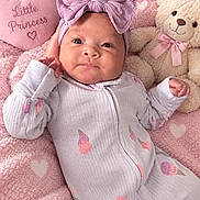 Alaia joined the competition — help win amazing prizes! baby, infant, child, portrait, lying_down, pink_blanket, teddy_bear, bow_headband, onesie, smiling, face, eyes, hands, nursery, soft_toy, heart_pattern, pink, indoor, cozy, photography