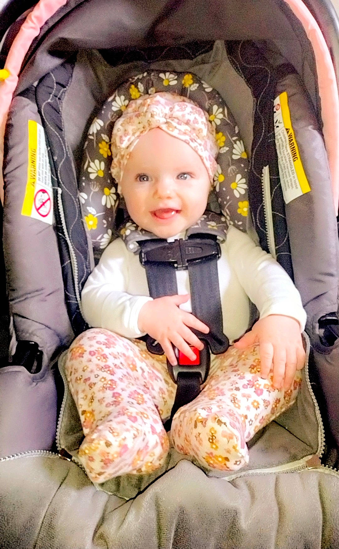 Aurora is registered to the contest to win money with this photo: baby, baby_carriage, baby_products, baby_toddler_clothing, bag, car_seat, chair, child, comfort, fun, happy, head, headwear, lap, leisure, person, sitting, smile, toddler, travel