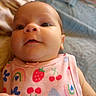 baby, infant, close_up, onesie, colorful_clothing, pattern, fruit_pattern, rainbow_pattern, cherry_pattern, strawberry_pattern, cute, face, skin, head, hand, person, portrait, indoors, soft_focus, background