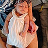 baby, infant, sleeping, dress, headband, leopard_print, pearl, arm, hand, lap, person, fabric, blanket, skin, resting, cute, indoors, comfort, child, peaceful
