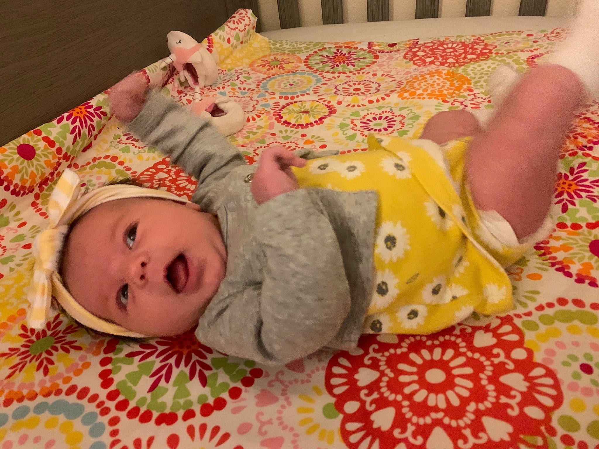 Persephone Rainn is registered to the contest to win money with this photo: baby, baby_toddler_clothing, cheek, child, comfort, facial_expression, finger, floor, flooring, headgear, human_body, linens, pattern, person, pink, skin, sleeve, textile, toddler, vertebrate