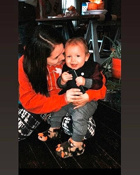 Kenai is registered to the contest to win money with this photo: baby, baby_toddler_clothing, chair, child, couch, darkness, event, eye, flash_photography, formal_wear, fun, gesture, happy, joy, lamp, person, room, sitting, smile, t_shirt