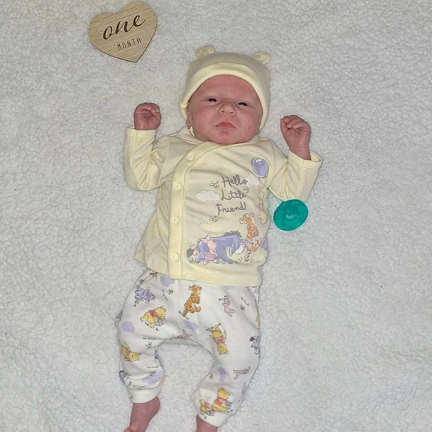 Oaklei Storm joined the competition — help win amazing prizes! baby, infant, one_month, pajamas, hat, blanket, lying_down, wooden_heart, pacifier, cute, newborn, soft_texture, winnie_the_pooh, cartoon_characters, sleepwear, small_hands, baby_clothes, portrait, indoors, child
