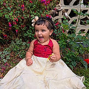 Gianna Tess is registered to the contest to win money with this photo: child, toddler, smiling, dress, grass, flower, greenery, outdoor, happy, candy, headband, nature, person, portrait, sitting, garden, cute, young, celebration, fun