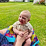 baby, blanket, child, clothing, crocheted, daytime, grass, greenery, hand, happy, house, laughing, nature, outdoor, person, smiling, sock, summer, truck, yard