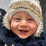 baby, child, smiling, hat, knitted_hat, winter_clothing, jacket, face, closeup, indoor, happy, cute, warm_clothing, person, infant, headwear, apparel, portrait, baby_face, toddler