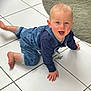 toddler, child, smiling, crawling, denim, overalls, navy_sweater, pacifier, floor, tile, white_tile, indoor, green_rug, happy, cute, baby, person, home, flooring, playful