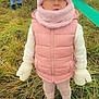 child, toddler, pink_panda_hat, mittens, pink_vest, boots, grass, outdoor, playground, people, winter_clothing, cute, warm, standing, curious, hat, vest, field, nature, play