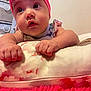 Aaliyah joined the competition — help win amazing prizes! baby, infant, headband, pink, bow, cushion, floral_pattern, hands, face, indoor, soft_texture, curious, chubby_cheeks, resting, closeup, portrait, child, cute, toddler, colorful_clothing