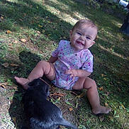 Sawyer joined the competition — help win amazing prizes! baby, child, grass, outdoor, puppy, dog, smiling, happy, onesie, barefoot, playing, nature, sunlight, leaves, pet, animal, infant, sitting, cute, young
