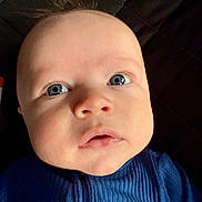 Nash joined the competition — help win amazing prizes! baby, close_up, face, blue_eyes, infant, child, portrait, clothing, quilted_background, expression, cute, young_child, indoor, person, head, skin, eyelashes, nose, mouth, soft_lighting