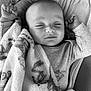 Loan a rejoint le concours — aidez-le/la à gagner de superbes lots ! baby, sleeping, blanket, infant, peaceful, soft, black_and_white, portrait, child, cute, resting, cozy, clothing, closeup, face, hands, indoor, comfort, young, relaxed